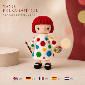May include: A crochet doll with bright red hair, wearing a white dress featuring colorful polka dots. The doll holds a small paintbrush in one hand and a paint palette in the other. The text YAYOI POLKA-DOT DOLL CROCHET PATTERN PDF is visible.