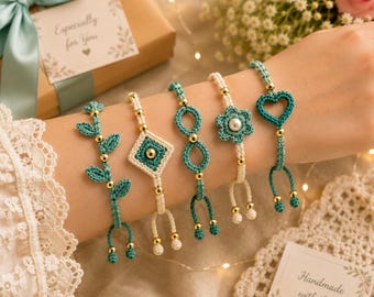 May include: Five bracelets featuring teal and cream crocheted designs with gold-toned beads. The patterns include a leaf vine, a diamond shape with a center bead, an infinity symbol, a flower with a pearl center, and a heart shape.