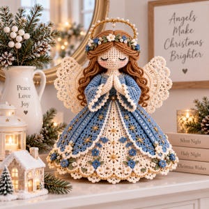 May include: A crocheted angel figurine with long brown hair, a gold halo, and a blue and white dress featuring floral accents and star patterns. The angel has hands clasped in prayer and intricate lace-like wings, standing as a decorative piece.