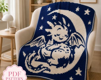May include: A dark blue and cream crochet blanket featuring a graphic of a dragon resting on a crescent moon surrounded by stars. The design is rendered in a pixelated style with a border. A pink label in the corner displays the text PDF PATTERN.