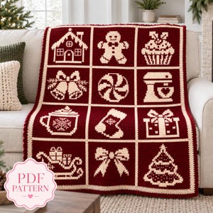 May include: A dark red and cream crochet blanket featuring a grid of twelve square panels with holiday motifs including a gingerbread house, gingerbread person, cupcake, bells, peppermint candy, stand mixer, mug, stocking, gift, sleigh, bow, and tree.