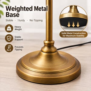 Puede incluir: Una base de l&aacute;mpara redonda de metal pesado con acabado de lat&oacute;n cepillado. La base cuenta con un poste vertical central y una almohadilla antideslizante negra en la parte inferior. El texto en la imagen incluye Weighted Metal Base, Stable, Sturdy, No Tipping, Heavy Weight, Stable Support, Prevents Tipping y Solid Metal Construction for Maximum Stability.