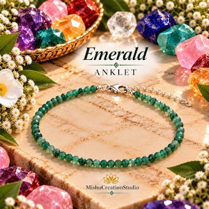 May include: An anklet featuring small, faceted green beads arranged in a circular pattern. The jewelry includes a silver-toned metal lobster clasp and an adjustable chain extension. The text "Emerald ANKLET" and "MishuCreationStudio" are visible.