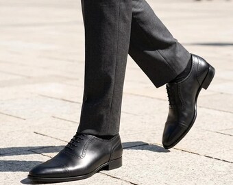 Sapatos sociais masculinos Oxford de couro preto com biqueira reforçada, feitos à mão, para ocasiões formais como casamentos e negócios. Calçados clássicos.
