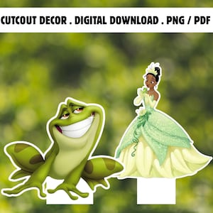 Puede incluir: Una decoración recortable digital que muestra una rana verde con una amplia sonrisa y un personaje con un vestido de gala verde claro y una tiara a juego. El texto en la parte superior dice CUTCOUT DECOR . DIGITAL DOWNLOAD . PNG / PDF.