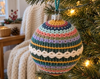 May include: A spherical Christmas ornament covered in a multi-colored crochet pattern featuring horizontal stripes of mustard yellow, dark blue, light blue, pink, sage green, lavender, and a central band of white decorative scalloped stitching.