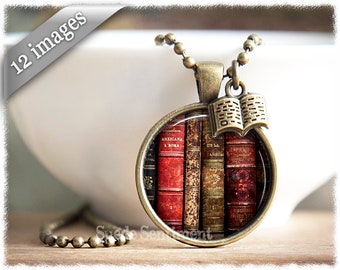May include: A bronze necklace with a round pendant featuring a close-up image of a stack of antique books. The pendant has a small bronze book charm attached to the top.