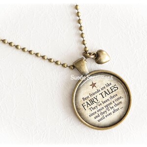 May include: A bronze necklace with a round charm that says "Best friends are like fairy tales. They've been there since once upon a time, and they'll be there until ever after..."