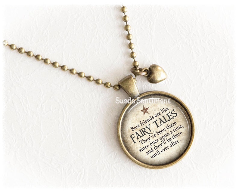 May include: A bronze necklace with a round charm that says "Best friends are like fairy tales. They've been there since once upon a time, and they'll be there until ever after..."