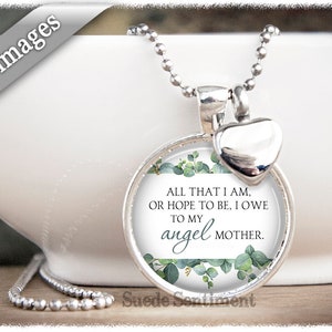 May include: Silver necklace with a round pendant featuring a green floral design and the text "ALL THAT I AM, OR HOPE TO BE, I OWE TO MY angel MOTHER." The pendant is attached to a silver chain with a small silver heart charm.