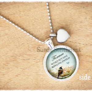 May include: Silver necklace with a round pendant featuring a blue and green image of a bird on a branch with the text "Forever would not have been long enough". The pendant also has a small heart charm.