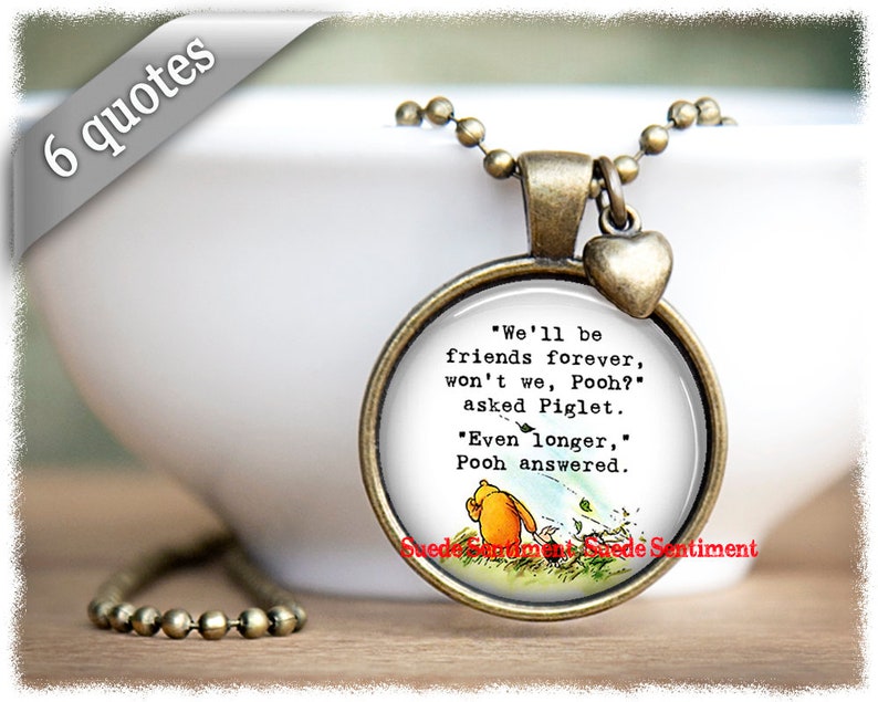 May include: A bronze necklace with a round glass pendant featuring a Winnie the Pooh illustration and the quote "We'll be friends forever, won't we, Pooh?" asked Piglet. "Even longer," Pooh answered.