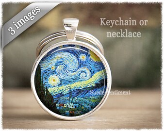 May include: A round silver keychain or necklace pendant featuring Van Gogh's "Starry Night" painting. The artwork depicts a swirling blue night sky with yellow stars over a village. The text "Keychain or necklace" is visible.