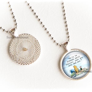 May include: A silver necklace with a round pendant featuring a Winnie the Pooh illustration and the quote "We'll be friends until forever, just you wait and see."