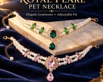 May include: Two pet necklaces featuring double strands of white pearls, gold-tone metal settings, and gemstone accents. One necklace has emerald green marquise and teardrop stones, while the other has light pink marquise and teardrop stones.