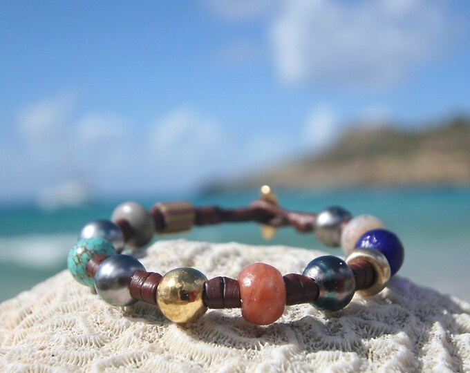 Leather bracelet from St Barth with 18K gold pearls and Tahitian black pearls and ancient African trading beads. Cultured black pearls