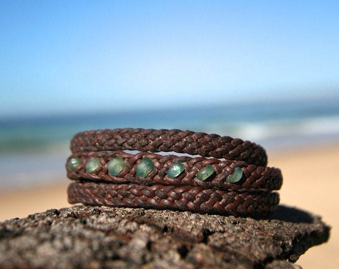 long leather bracelet featuring genuine emerald faceted stones and Tahitian pearl clasp to wrap three time around the wrist.