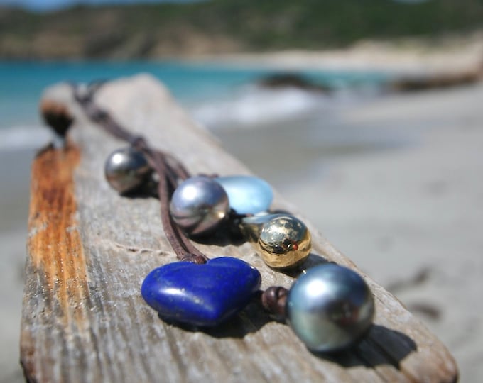 Charms leather necklace from St Barth with Gigantic Tahitian black pearls, solid 18K gold drop, sea-glass element and Lapis lazuli Heart