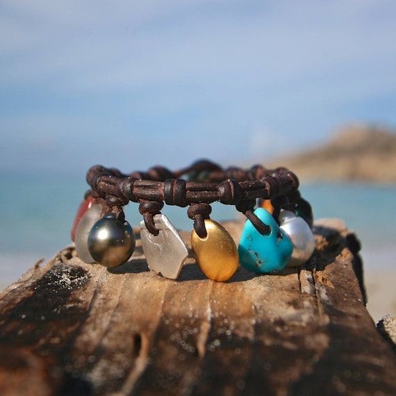 Charms genuine treasures and Gold pebble leather bracelet, cultured Tahitian fine pearls bohochic beach jewelry St Barth signature.