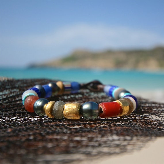 24k pure gold beads strung on leather with Tahitian black pearls and ancient African trading beads. Cultured black pearls, jewelry St Barth