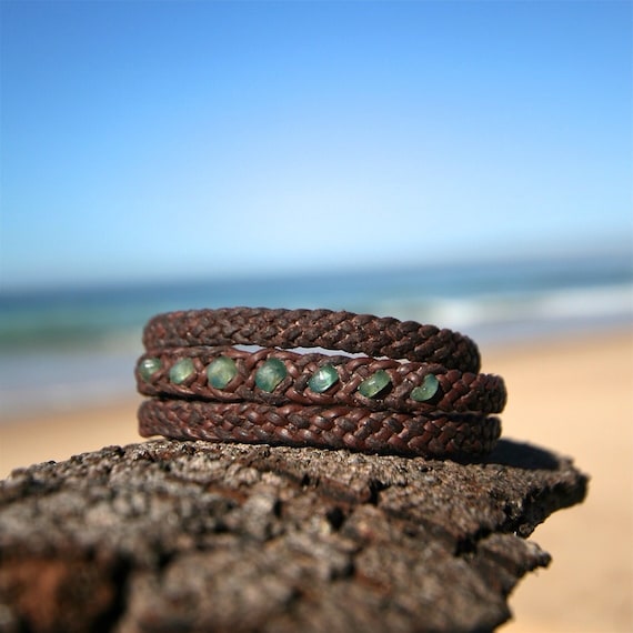 long leather bracelet featuring genuine emerald faceted stones and Tahitian pearl clasp to wrap three time around the wrist.