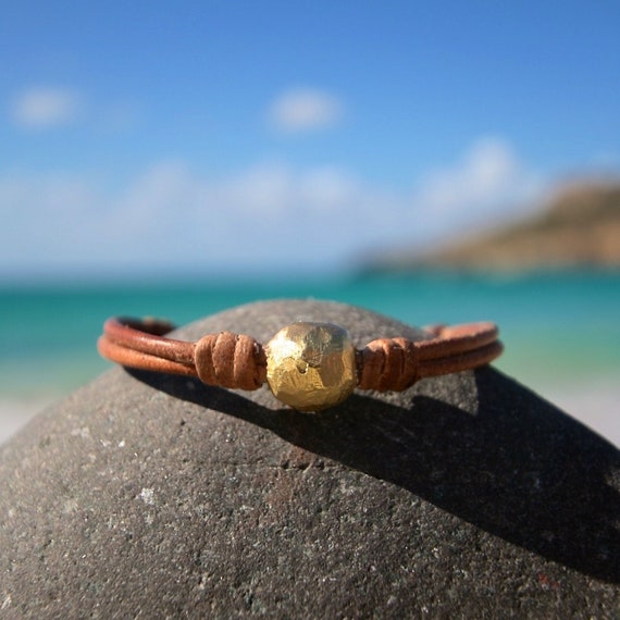 Super chic boho bracelet : Solid 18k gold handmade bead strung on leather. luxury jewelry, one of a kind plain gold design, St Barth island