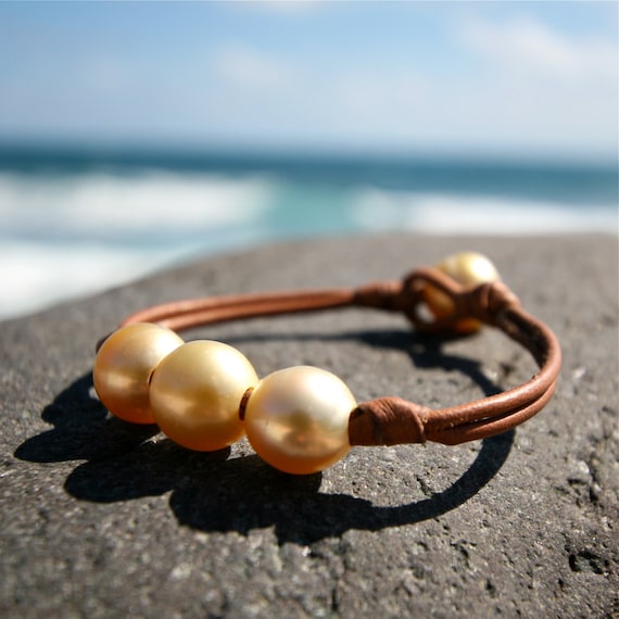 Trio of golden Australian pearls and leather.