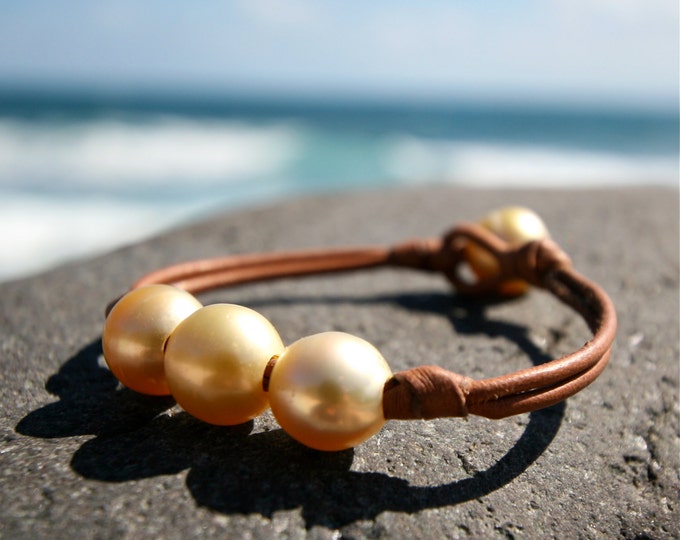 Trio of golden Australian pearls and leather.