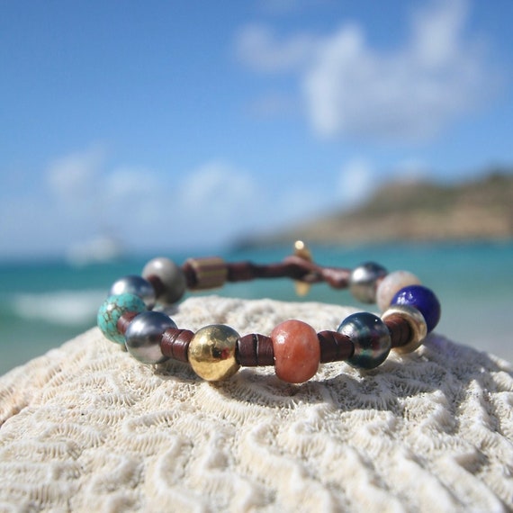 Leather bracelet from St Barth with 18K gold pearls and Tahitian black pearls and ancient African trading beads. Cultured black pearls