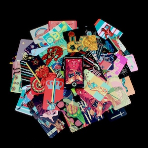 May include: A colorful deck of tarot cards with illustrations of various figures and symbols. The cards are arranged in a circular pattern with the title "The Illuminated Tarot" visible on one card.