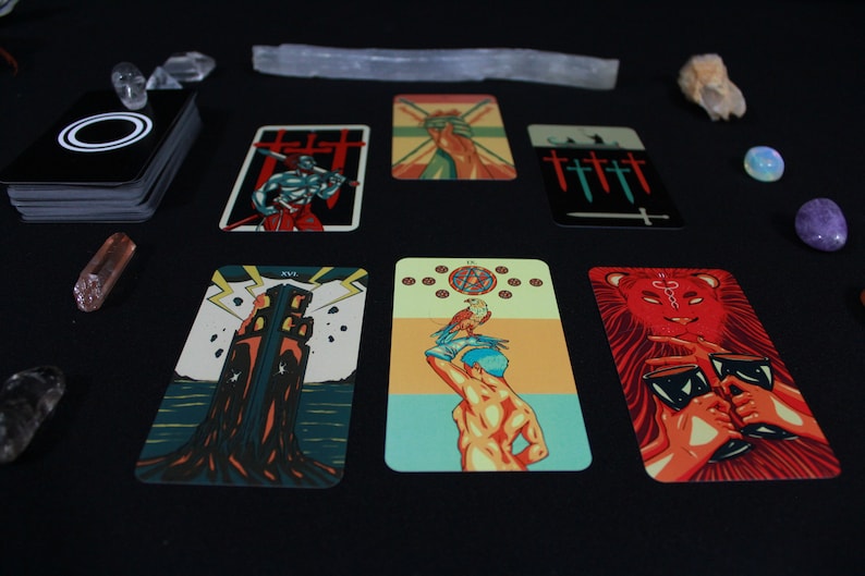 May include: Tarot card spread with ten cards laid out on a black surface. The cards feature colorful illustrations of various figures and symbols, including a tower, a lion, and a hand holding a sword.