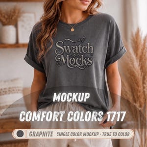 May include: A charcoal gray short-sleeve t-shirt with rolled sleeves featuring the text Swatch Mocks in a stylized font. The shirt includes the text MOCKUP COMFORT COLORS 1717 and GRAPHITE SINGLE COLOR MOCKUP TRUE TO COLOR printed on the image.