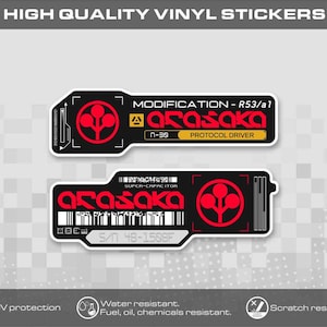May include: Two rectangular vinyl stickers with rounded corners, featuring black backgrounds, red Arasaka logos, and white text. The top sticker reads MODIFICATION - R53/a1 and PROTOCOL DRIVER. The bottom sticker displays SUPER-CAPACITOR and S/N 48-1508F.