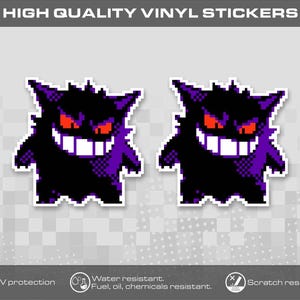 Peut inclure: Deux autocollants en vinyle identiques en pixel art représentant une créature violette et noire avec des oreilles pointues, des yeux rouges brillants et un large sourire blanc. Le texte HIGH QUALITY VINYL STICKERS est visible en haut.