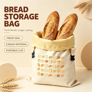 May include: A cream-colored canvas bread storage bag featuring a pattern of small cartoon bread icons. The bag has a wide opening, a light yellow interior lining, and black plastic side clips. Text on the bag reads BREAD STORAGE BAG.