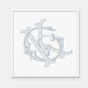 May include: A square framed wall art piece featuring a light blue, intricate, calligraphic monogram of the letters K and G. The design uses detailed line work and decorative flourishes, set against a plain white background within a white frame.