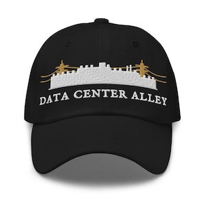 May include: A black baseball cap featuring an embroidered white skyline graphic of industrial buildings and power lines in gold thread. Below the graphic, the text DATA CENTER ALLEY is embroidered in white capital letters on the front panel.