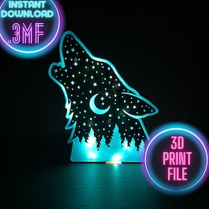 May include: A laser-cut wooden wolf head silhouette with a starry sky and crescent moon design. The wolf is howling, with a forest scene at the base. The design is illuminated with blue LED lights. Text on the image says "Instant Download .3MF" and "3D Print File."