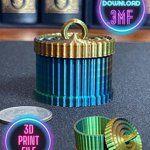 May include: A 3D printed, teal and gold, cylindrical container with a lid. The lid has a small, circular handle. The container is about 2 inches tall. The image also shows a smaller version of the container in green and gold.