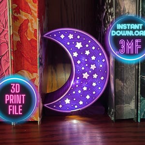 May include: A purple crescent moon-shaped lamp with star cutouts, nestled among books on a wooden shelf. The lamp is illuminated, casting a soft glow. The text "3D PRINT FILE" and "INSTANT DOWNLOAD .3MF" are visible.