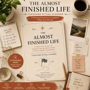 May include: A planner titled The Almost Finished Life, a practical guide to completing projects. The cover features a compass icon, a checkered flag, and text about finishing rituals. It is surrounded by a notepad, a photo, sticky notes, and clips.