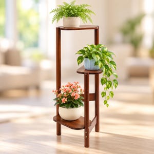 May include: A three-tiered dark brown wooden plant stand with rounded shelves. The top shelf holds a fern in a beige pot, the middle shelf holds a trailing pothos in a light blue ribbed pot, and the bottom shelf holds pink flowers in a white pot.