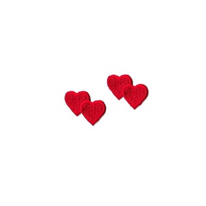May include: Four red felt heart patches. The hearts are about 1 inch in size.