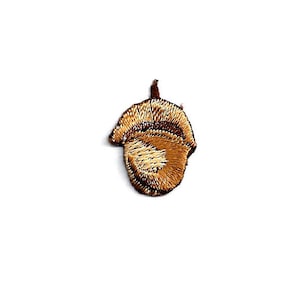 May include: A brown embroidered acorn patch with a light brown center.