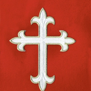 May include: A white cross with gold trim is embroidered on a red fabric background.