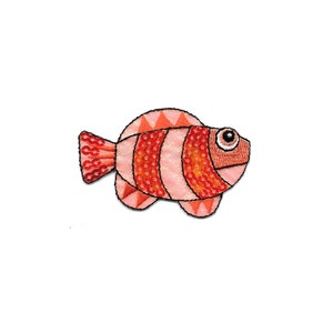 May include: A pink and orange fish with a large eye and a striped pattern. The fish is made of fabric and has a 3D effect.