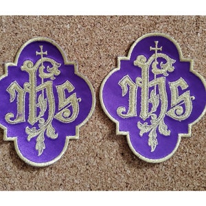 May include: Two purple fabric patches with gold embroidered lettering that reads "IHS" with a cross above the letters.