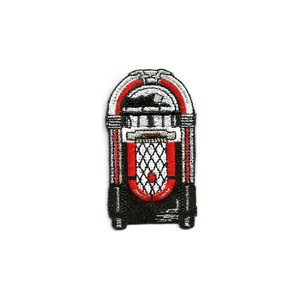 May include: A black and red vintage-style jukebox with a white grill and a red stripe around the middle. The jukebox has a silver handle and a silver coin slot.
