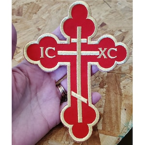 May include: Red embroidered cross patch with gold trim and the letters "IC XC" in gold.
