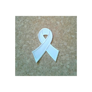 May include: White ribbon patch, a symbol of support and awareness.
